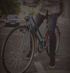 A mint-green step-through commuter bike on a city street